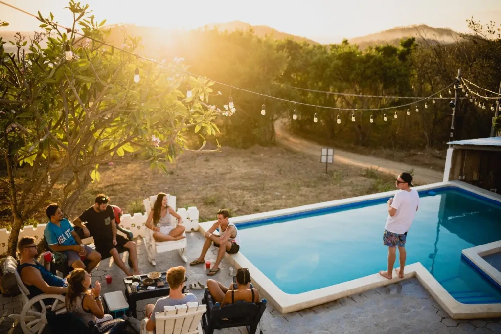 A gathering of individuals enjoying leisure time by a poolside.