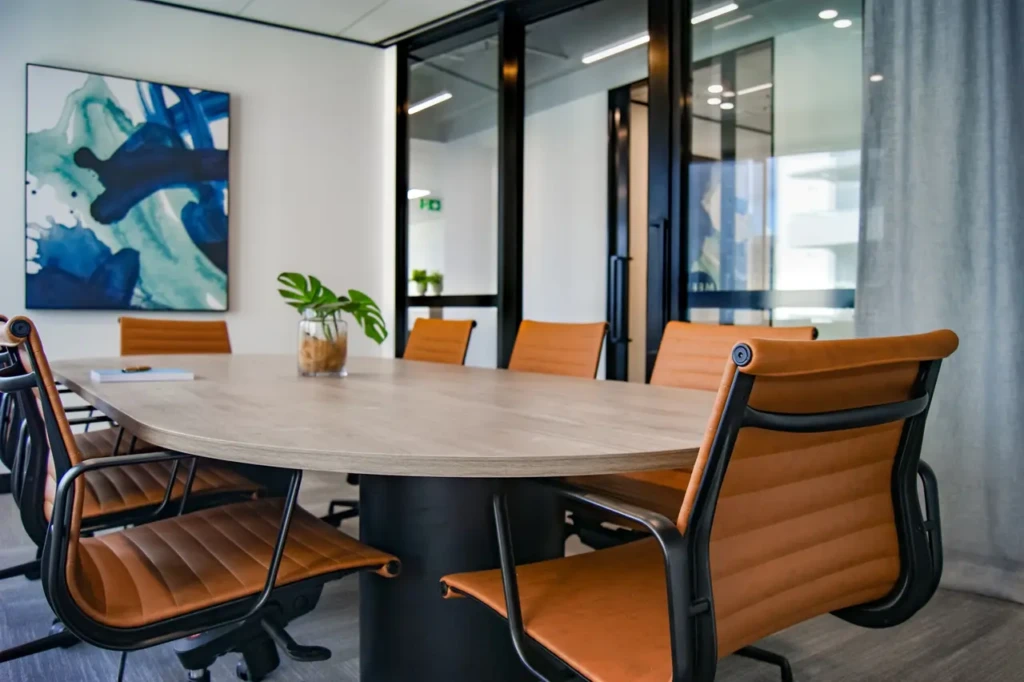 A conference room with a table and chairs, suitable for meetings and discussions.